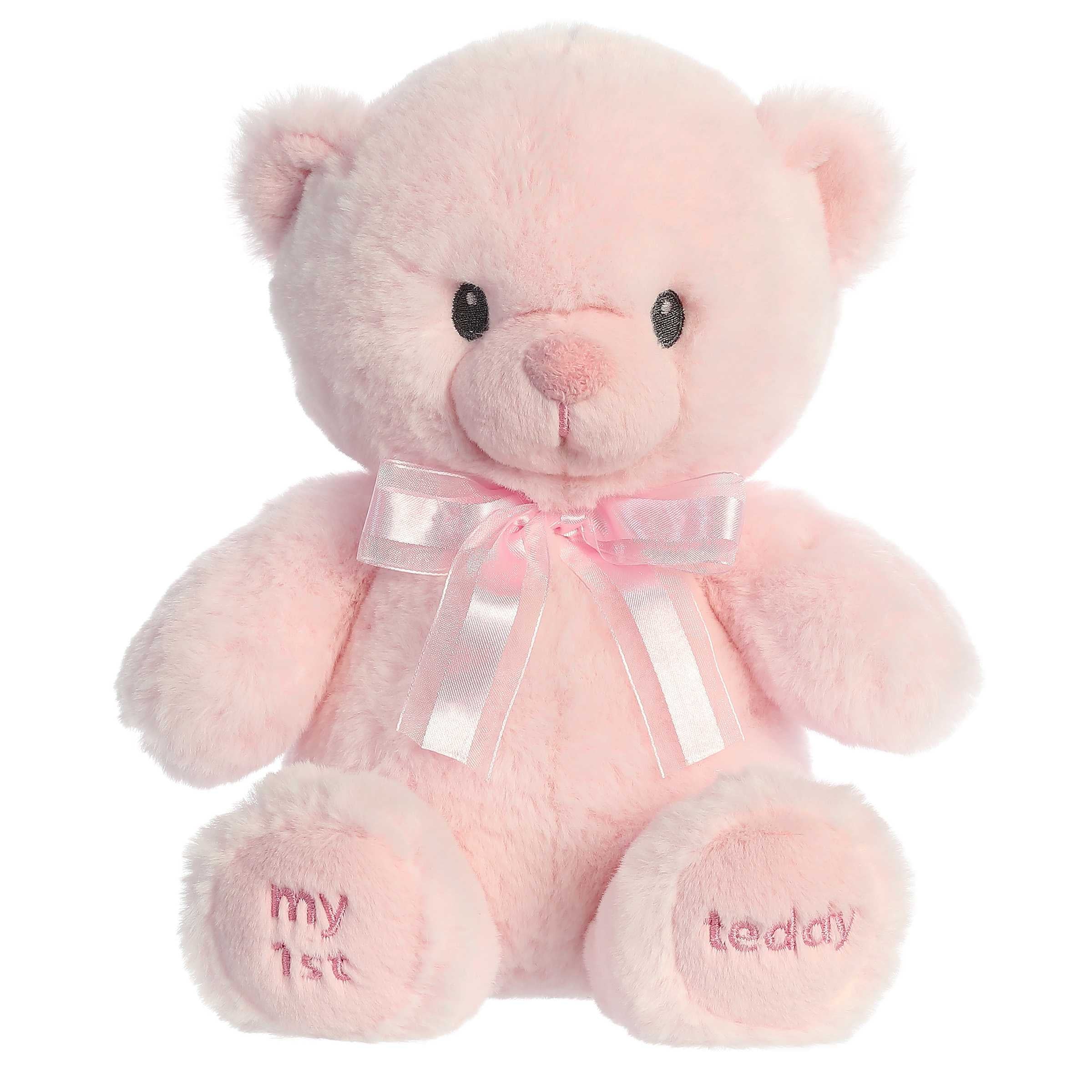 A pink teddy bear plush toy from ebba baby toys with a satin bow and embroidered eyes.