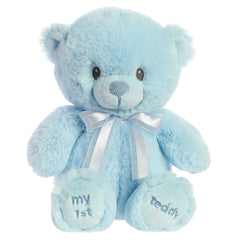 A blue teddy bear plush toy from ebba with embroidered eyes and a matching satin bow.