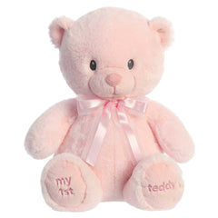 A pink teddy bear plush toy from ebba baby toys with a satin bow and embroidered eyes.