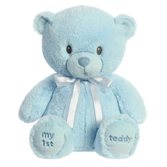 A blue teddy bear plush toy from ebba with embroidered eyes and a matching satin bow.
