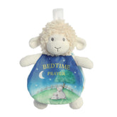 Cream-colored lamb plush toy from ebba by Aurora with floppy ears and a soft crinkle book for bedtime prayers.