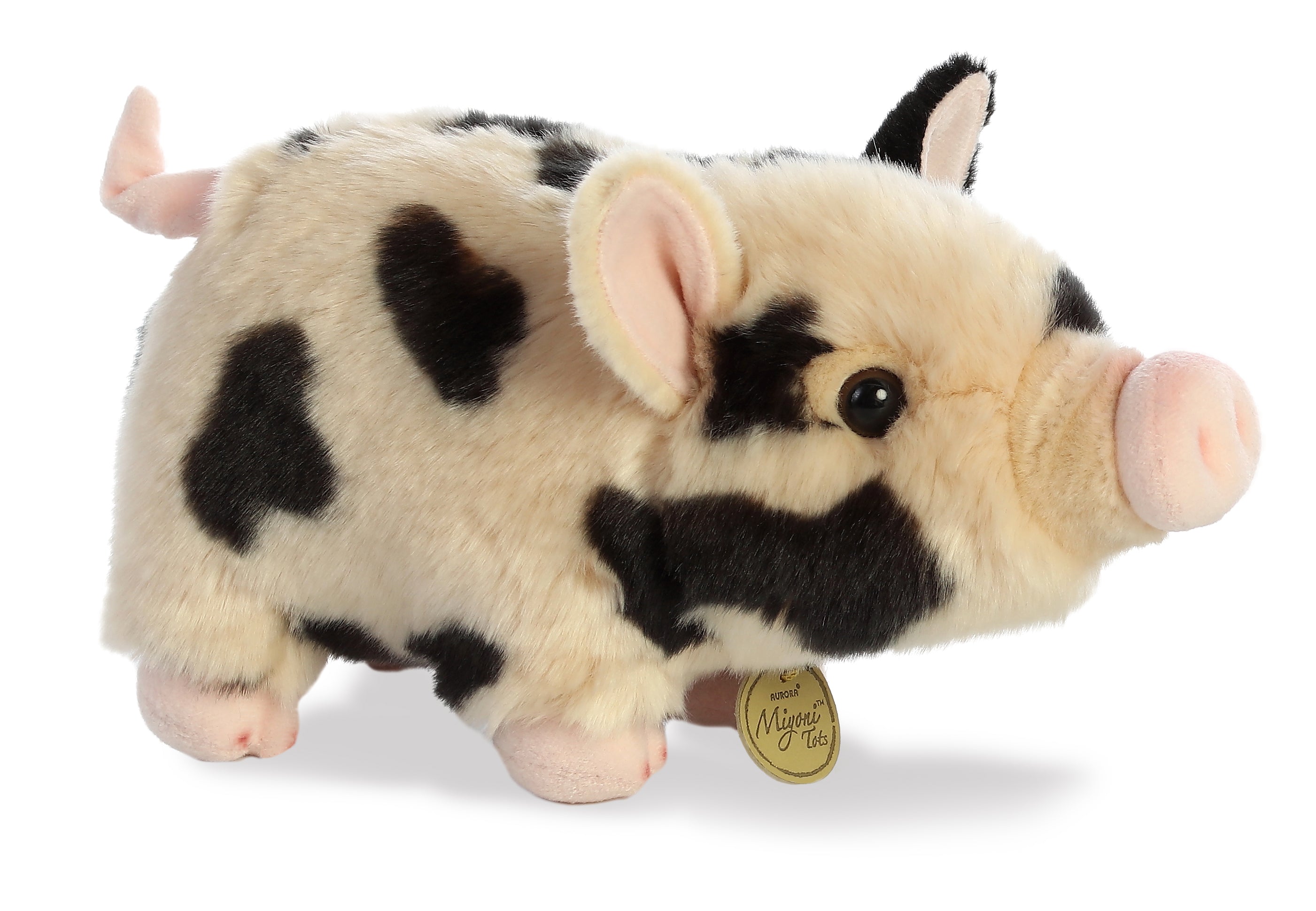 A spotted pot-bellied piglet plush toy from Miyoni Tots by Aurora with cream fur and black markings
