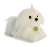 A Maltese puppy plush toy from Miyoni Tots by Aurora with long white fur and a pink bow on its head.