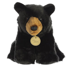 A black bear plush toy from Miyoni by Aurora with a brown muzzle and soulful, gentle eyes.