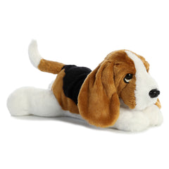 Plush toy of a Basset Hound with droopy ears, tan and white fur, and a sweet expression by Aurora stuffed animals.