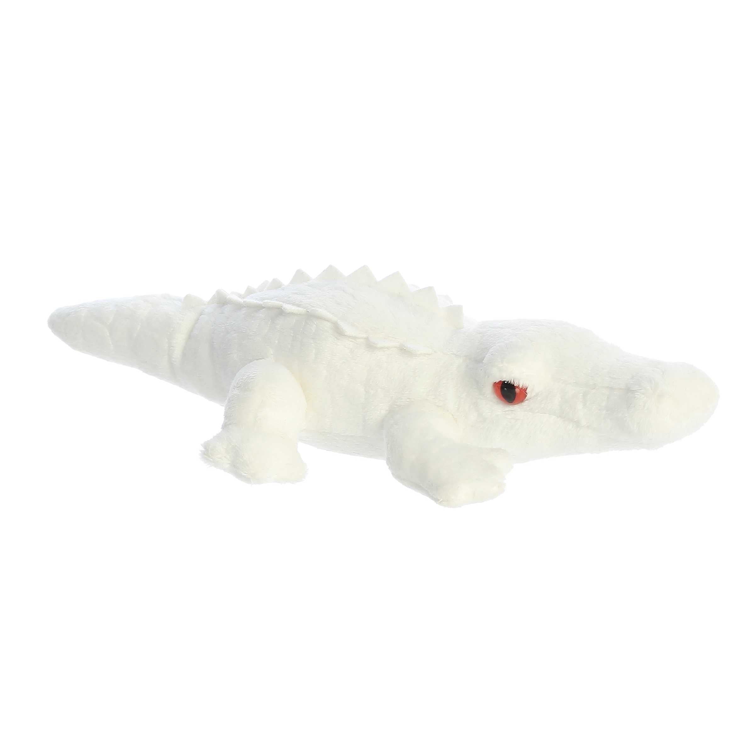 Distinctive albino alligator plush with white color, red eyes, and textured scales, capturing its unique charm, by Aurora.