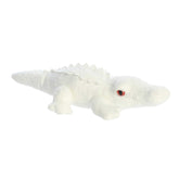 Distinctive albino alligator plush with white color, red eyes, and textured scales, capturing its unique charm, by Aurora.