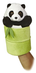 A panda hand puppet toy from Aurora with black and white fur peeking from a green bamboo shoot.