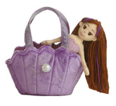 A lavender mermaid plush in a seashell-shaped carrier with glitter accents and flowing hair.