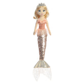 A mermaid plush toy with a peach tutu from Sea Sparkles by Aurora with a sparkling tail and blonde hair.