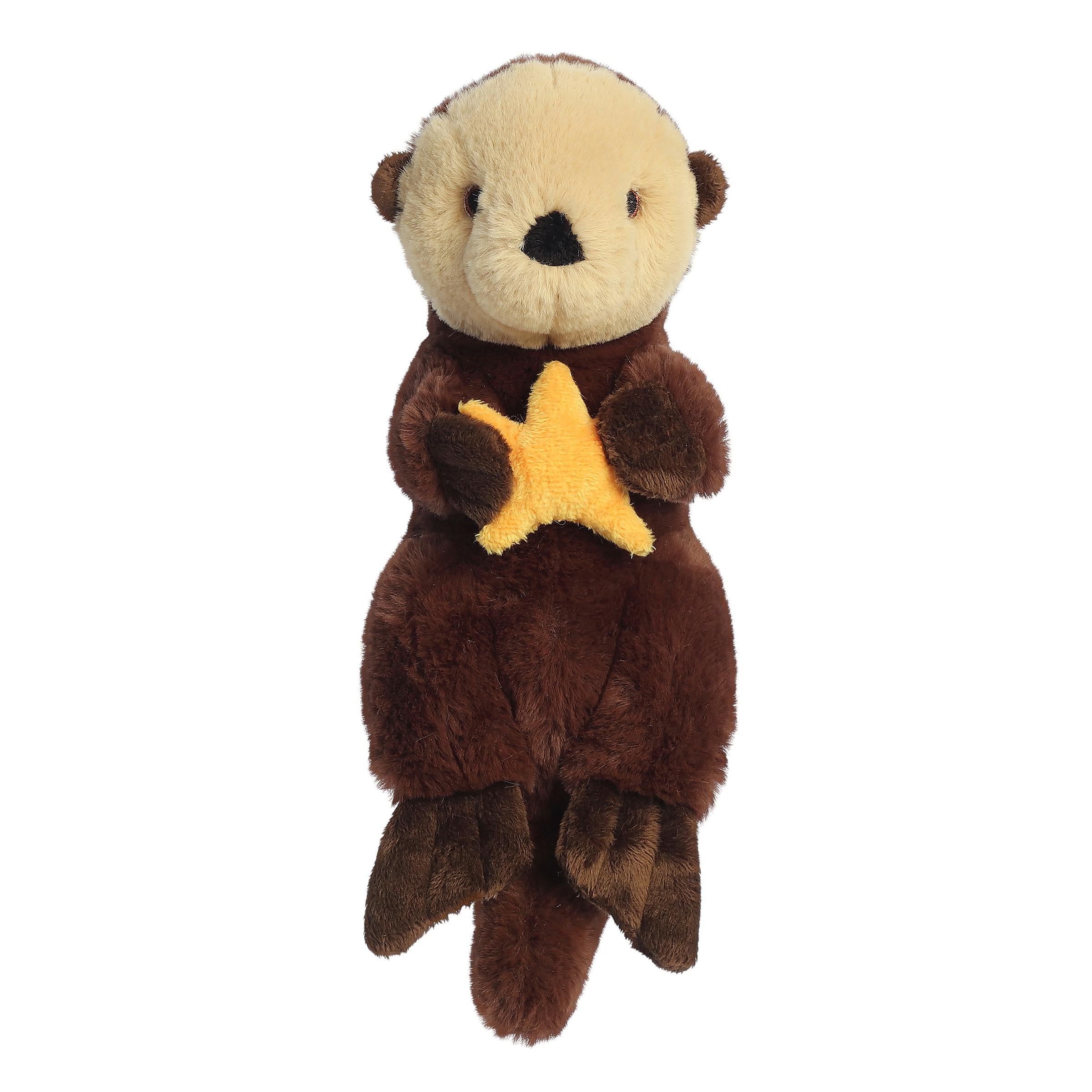 A playful sea otter plush with a rich brown coat holding a yellow seastar, embroidered eyes, and an eco-nation tag