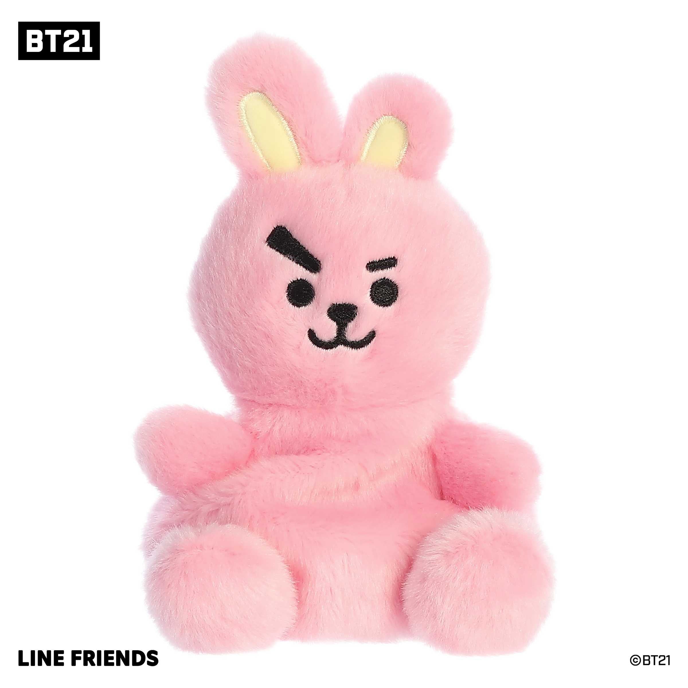 Adorable mini BT21 plush toy with a fluffy pink fur body, yellow accents on ears, and black accents on a smiling face