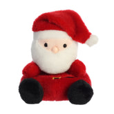 A Santa Claus plush toy from Palm Pals with a red suit, white beard, and pom-pom hat