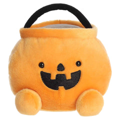 Large orange pumpkin candy bucket plush with a smiling jack-o'-lantern face