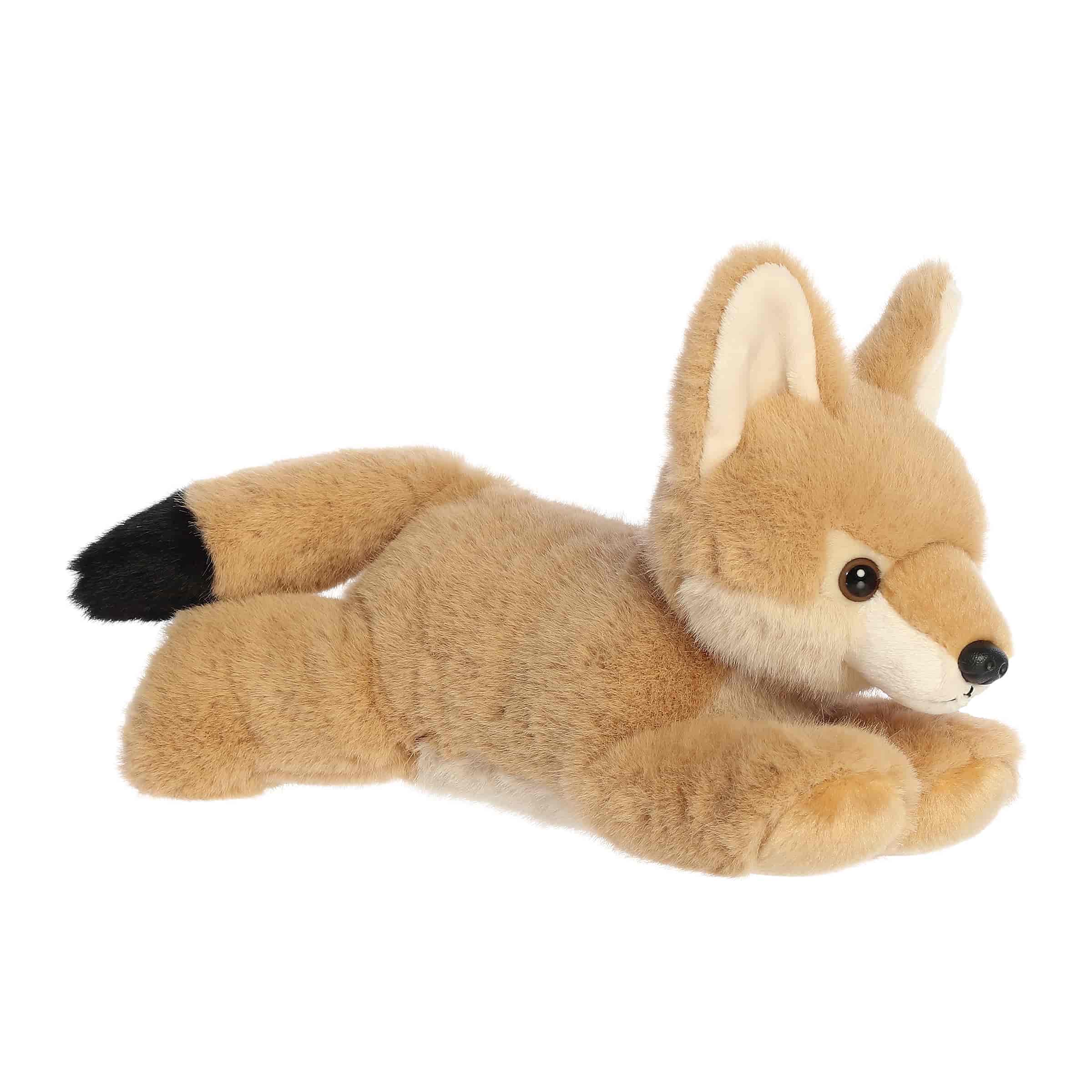 A soft tan plush coyote with pointed ears and a floppy body from Flopsie by Aurora.
