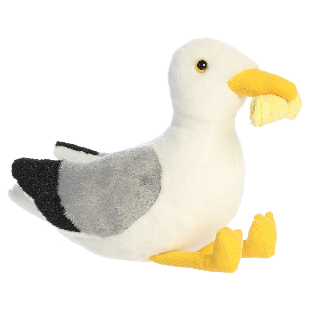 A seagull plush toy from Aurora with white and gray fur, yellow feet, and a crinkle cut fry in its beak.