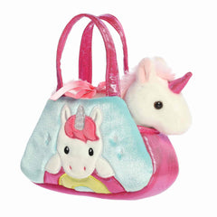 White unicorn plush with pink mane and horn inside rainbow-themed carrier with satin bow and pink handles