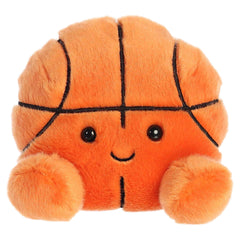Hoops is a vibrant orange plush with black lines crisscrossing to mimic a basketball's segments, and her cheerful face!