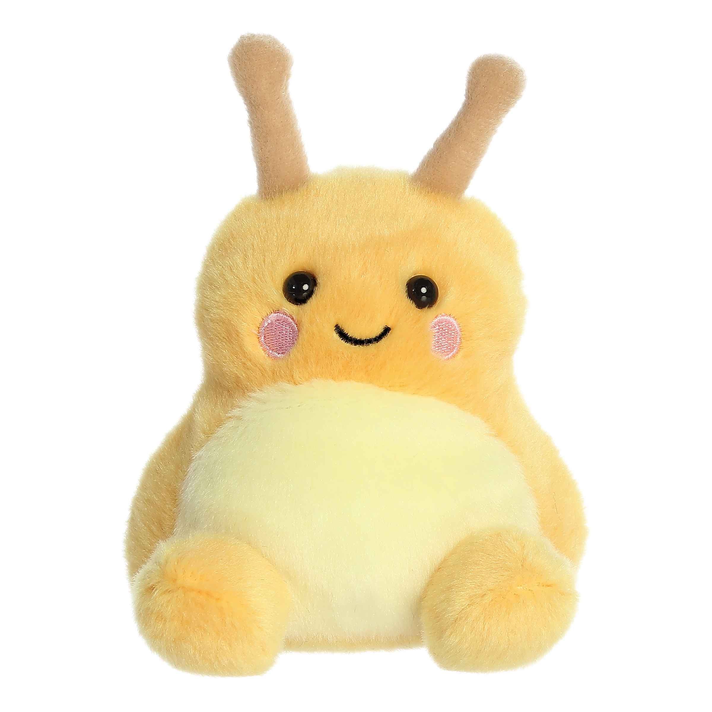 Plush toy of a yellow banana slug in the Palm Pals collection with pink cheeks and sparkly eyes.