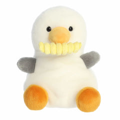 Plush toy of a white seagull with grey wings, orange feet, and a fry in its beak from the Palm Pals collection.