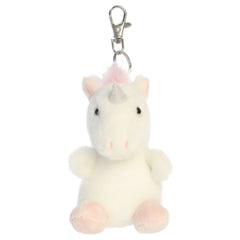 A unicorn plush clip-on from Aurora with white fur, a pink mane, pink hooves, and pastel accents.