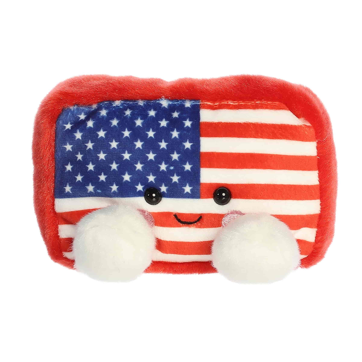 A small red, white, and blue flag plush with embroidered cheeks from Palm Pals by Aurora.