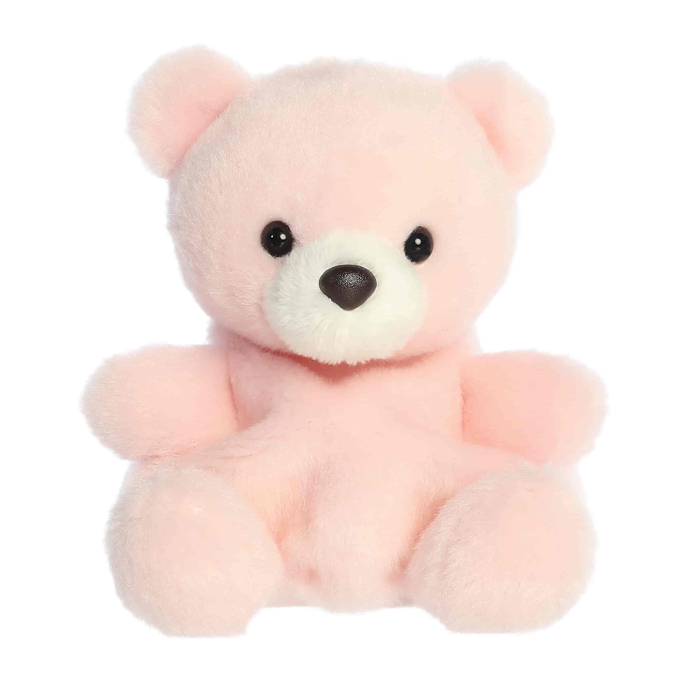 A small pastel pink bear plush with a white snout and sweet expression from Palm Pals by Aurora.