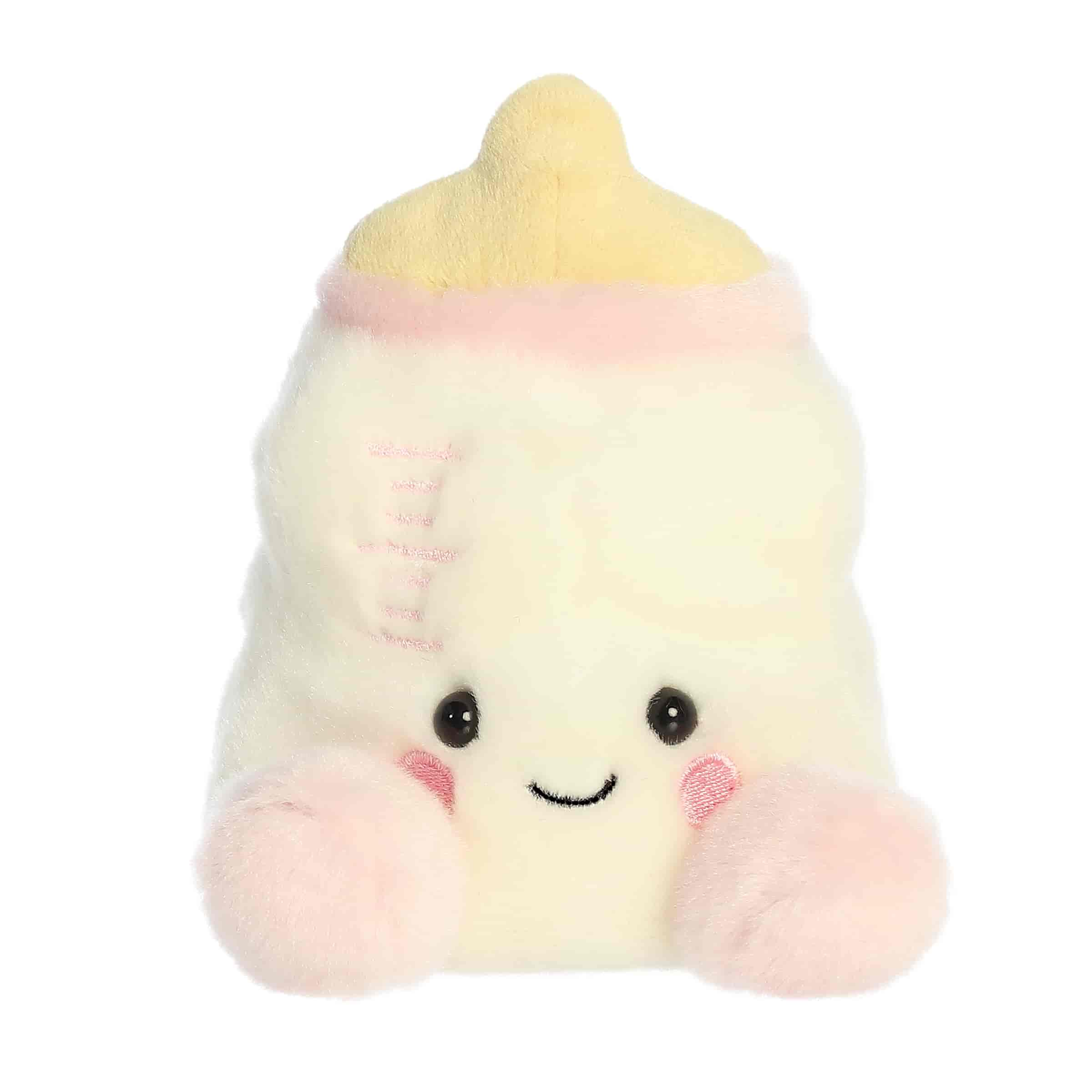 A small white baby bottle plush with pastel pink accents and embroidered details from Palm Pals by Aurora.