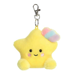 A small yellow star plush clip-on with rosy cheeks and a pastel rainbow accent from Palm Pals