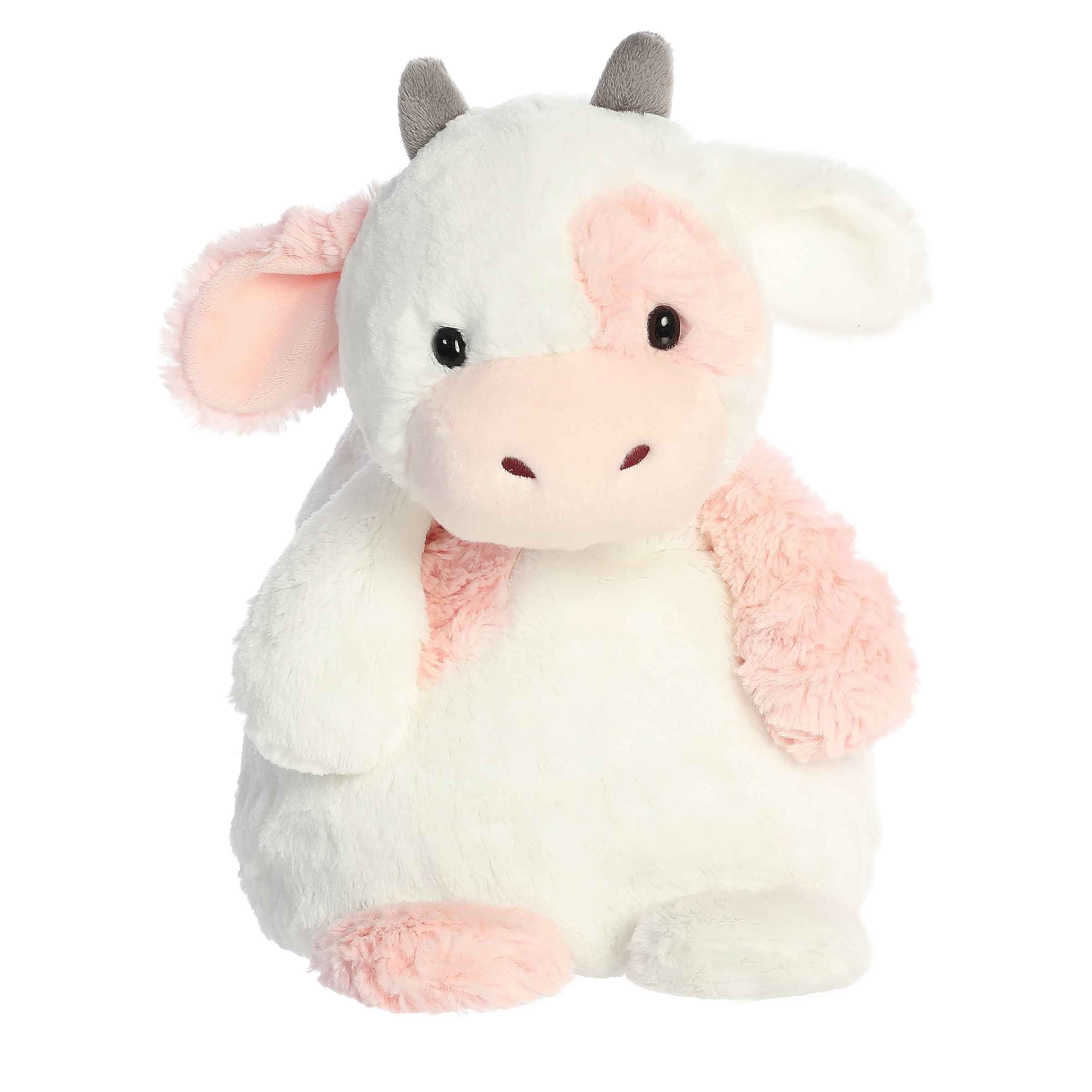 Serene Strawberry Cow plush, pink and white fur, seated with inviting eyes and warm smile from Huggle Pals