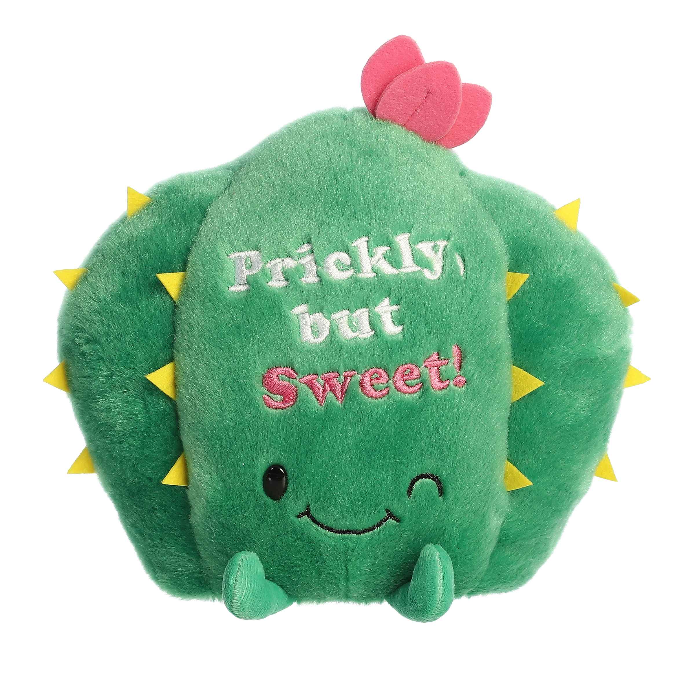 Plush toy of a cactus from the Just Sayin' collection with a pink flower, yellow spikes, and "Prickly but Sweet" embroidered text.