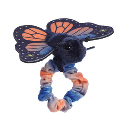 A plush Sunset Butterfly with coral and navy starry wings from Aurora’s Wrist Fliers collection.