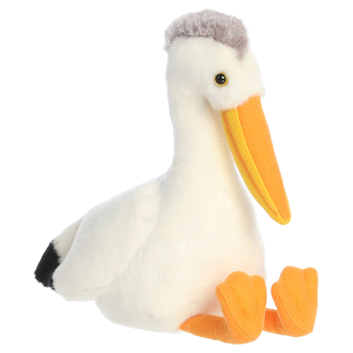 A pelican plush toy from Aurora with white fur, a golden beak, and orange feet.