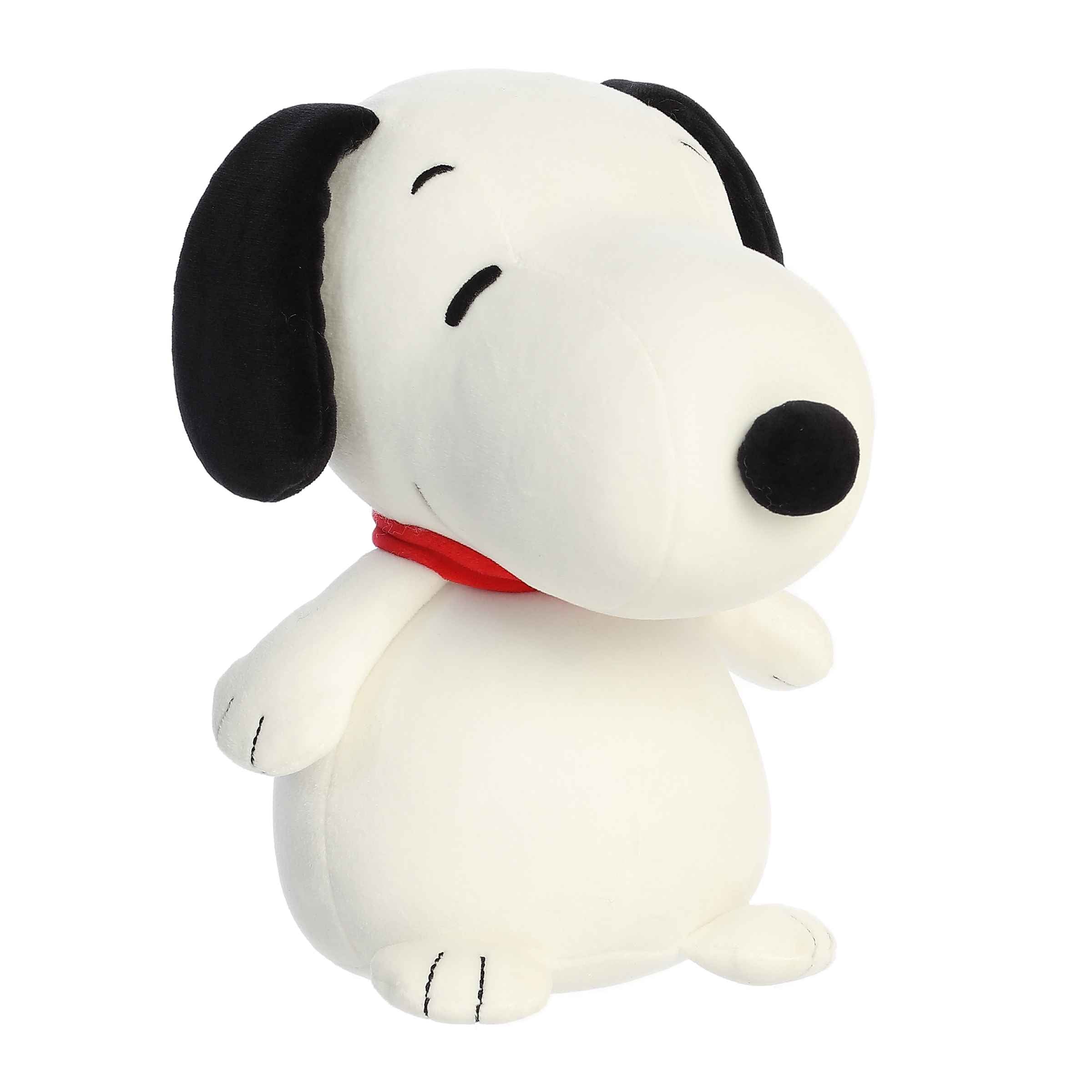 Plush of Snoopy from the Peanuts collection in a seated position with beans in the base for stability.