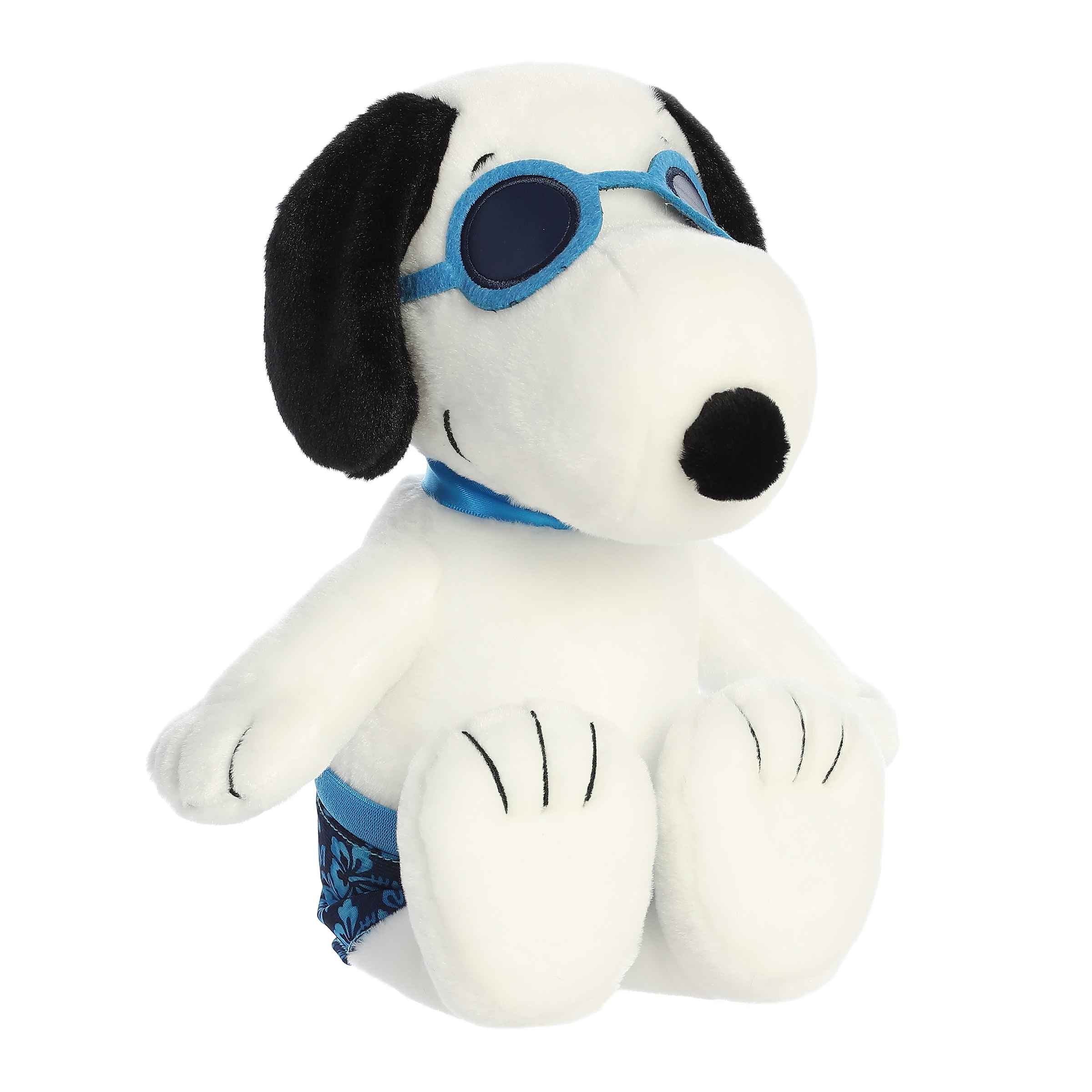 Plush of Snoopy dressed in blue board shorts and sunglasses from the Peanuts collection