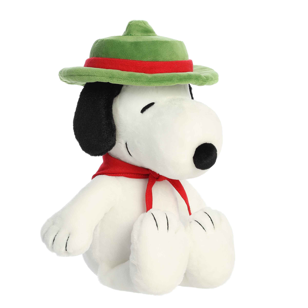 Plush of Snoopy dressed as a Beagle Scout, wearing a green scout hat and red neckerchief from the Peanuts collection.