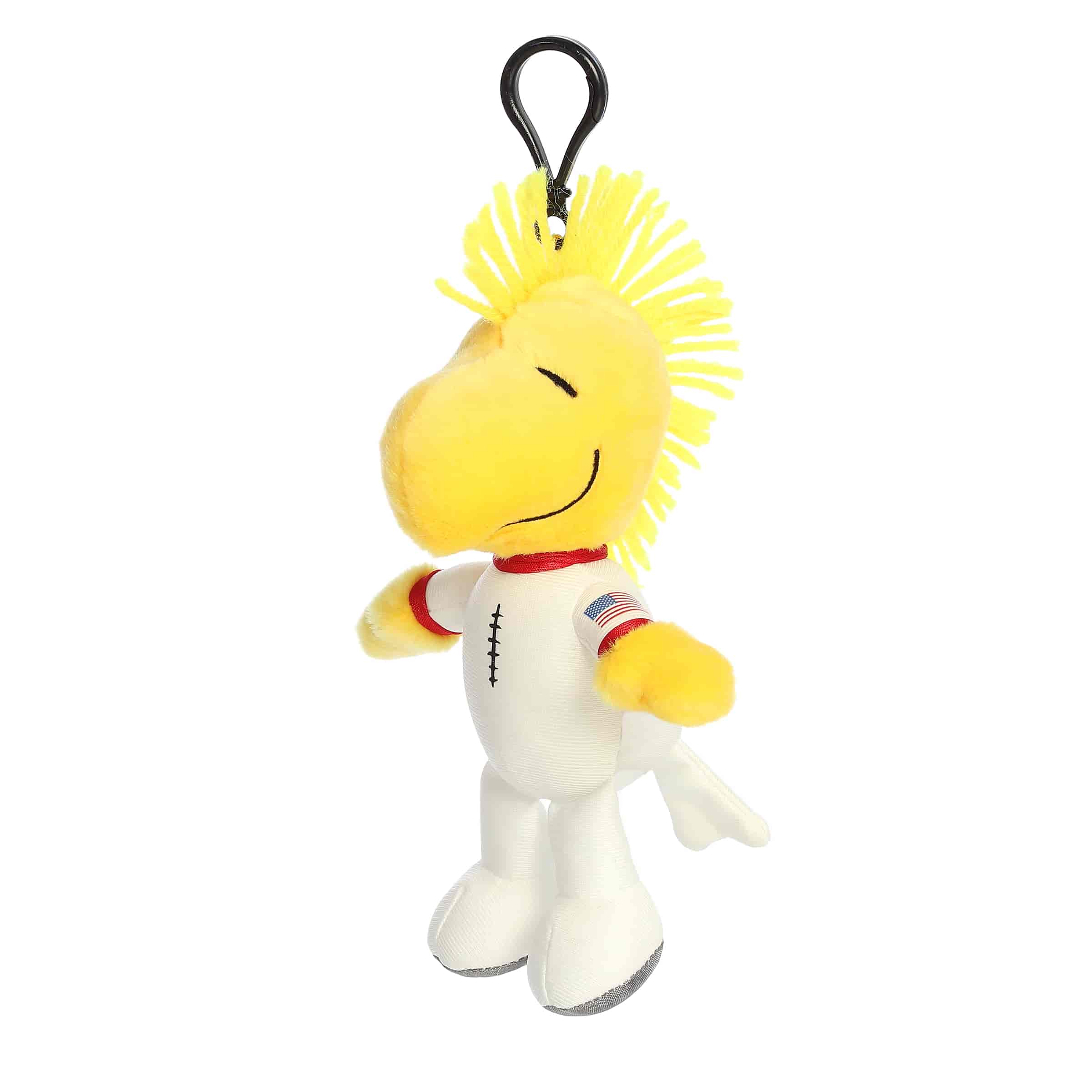 A yellow Woodstock clip-on plush wearing a white astronaut suit from the Peanuts collection by Aurora