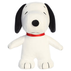 A Snoopy plush toy from Aurora with his signature look and beans in his feet.