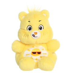 Funshine Bear Palm Pals plush with soft yellow fur, cheerful smile, round ears, and smiling sun belly badge