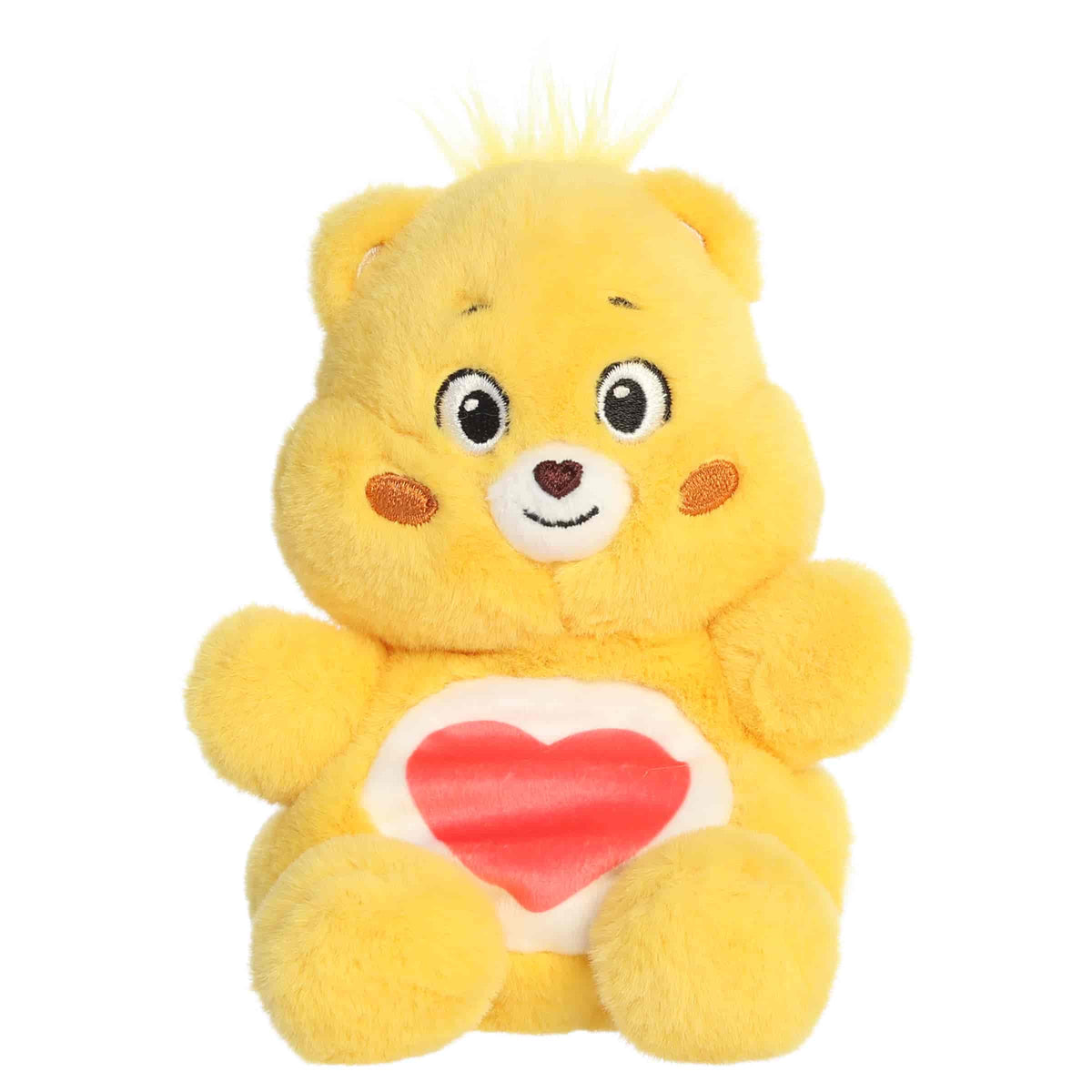 Tenderheart Bear Palm Pals plush with soft golden fur, gentle smile, round ears, and red heart belly badge