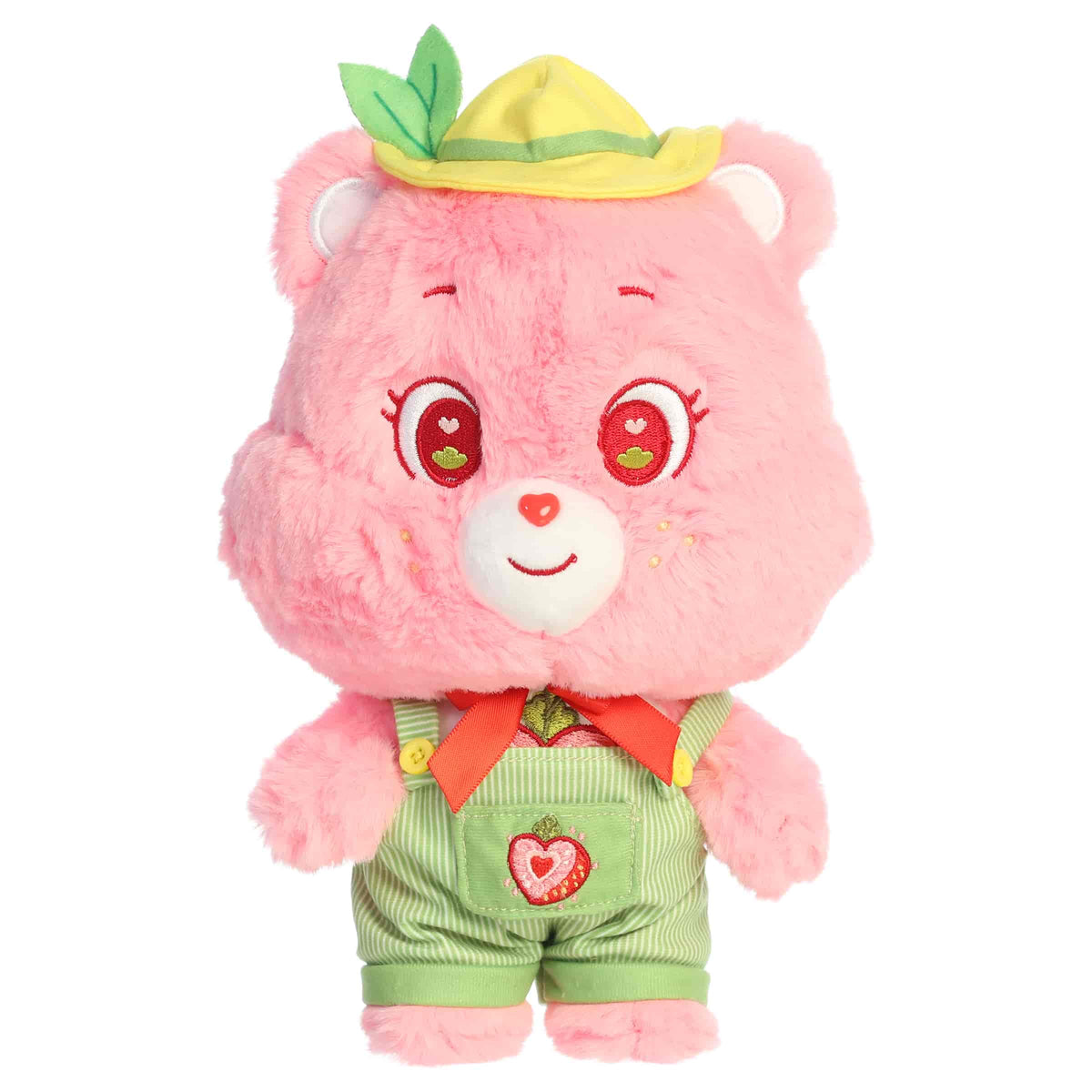 Cheer Bear dressed plush with pink fur, sweet smile, green outfit, and soft rounded ears