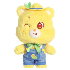 Funshine Bear dressed plush with yellow fur, winking face, soft ears, and colorful outfit details