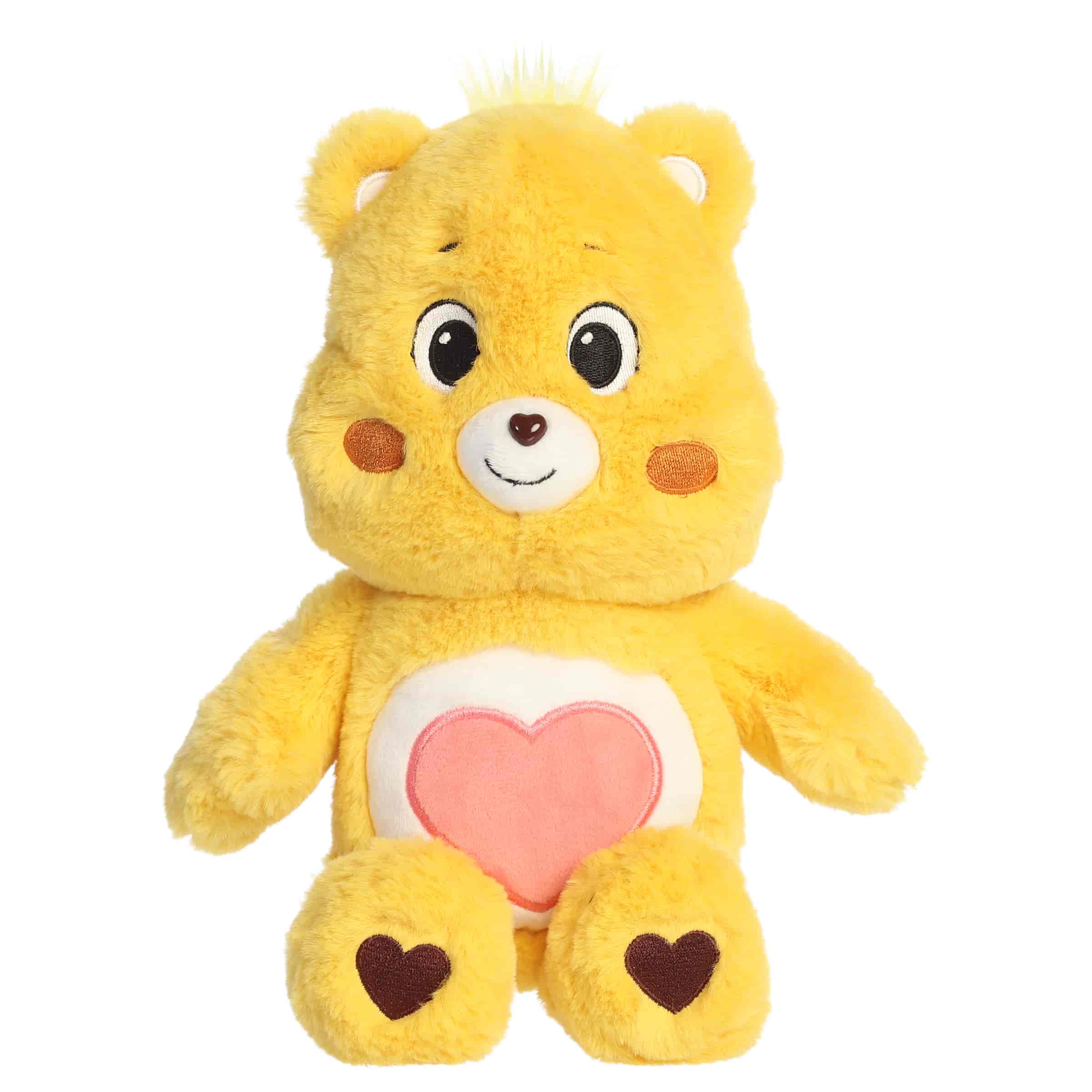 Tenderheart Bear plush with soft golden fur, sweet smile, round ears, and red heart belly badge