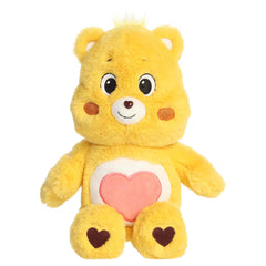 Tenderheart Bear plush with soft golden fur, sweet smile, round ears, and red heart belly badge