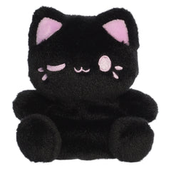 A black cat plush toy from Aurora with rounded paws, taro purple inner ears, and a matching winking expression.