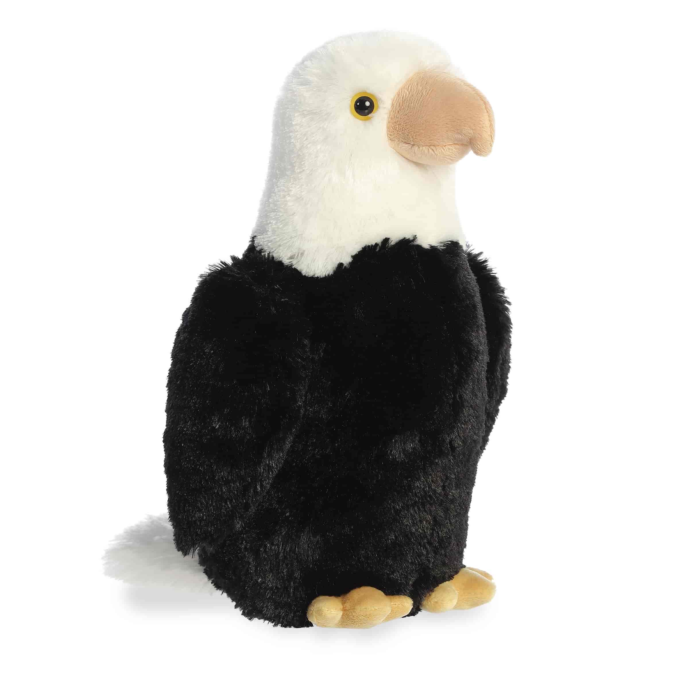A plush eagle toy from Aurora with a white head, black body, and tan beak and talons.
