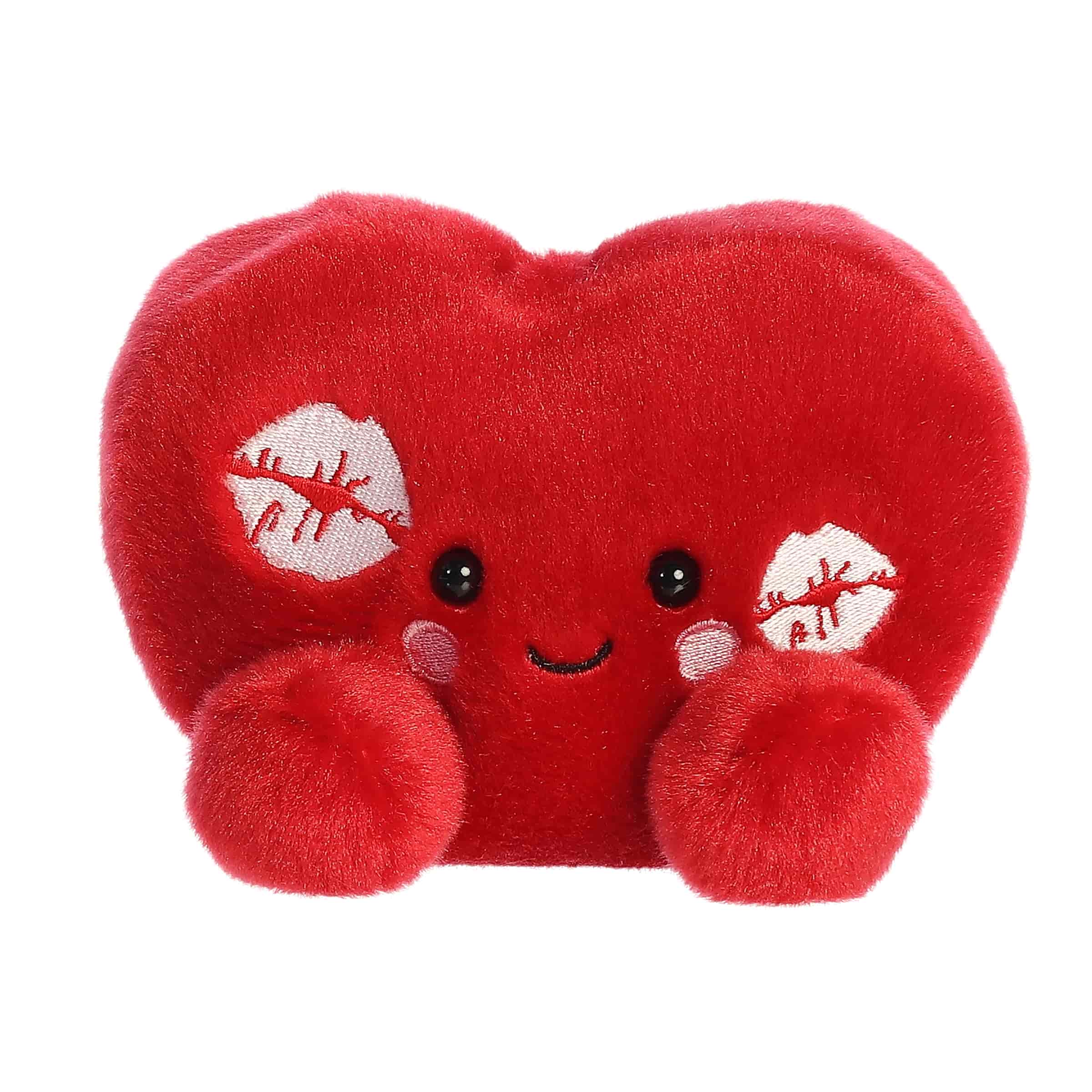 A red heart-shaped plush with kiss marks and rosy cheeks from the Palm Pals Valentine's Collection
