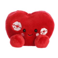A red heart-shaped plush with kiss marks and rosy cheeks from the Palm Pals Valentine's Collection