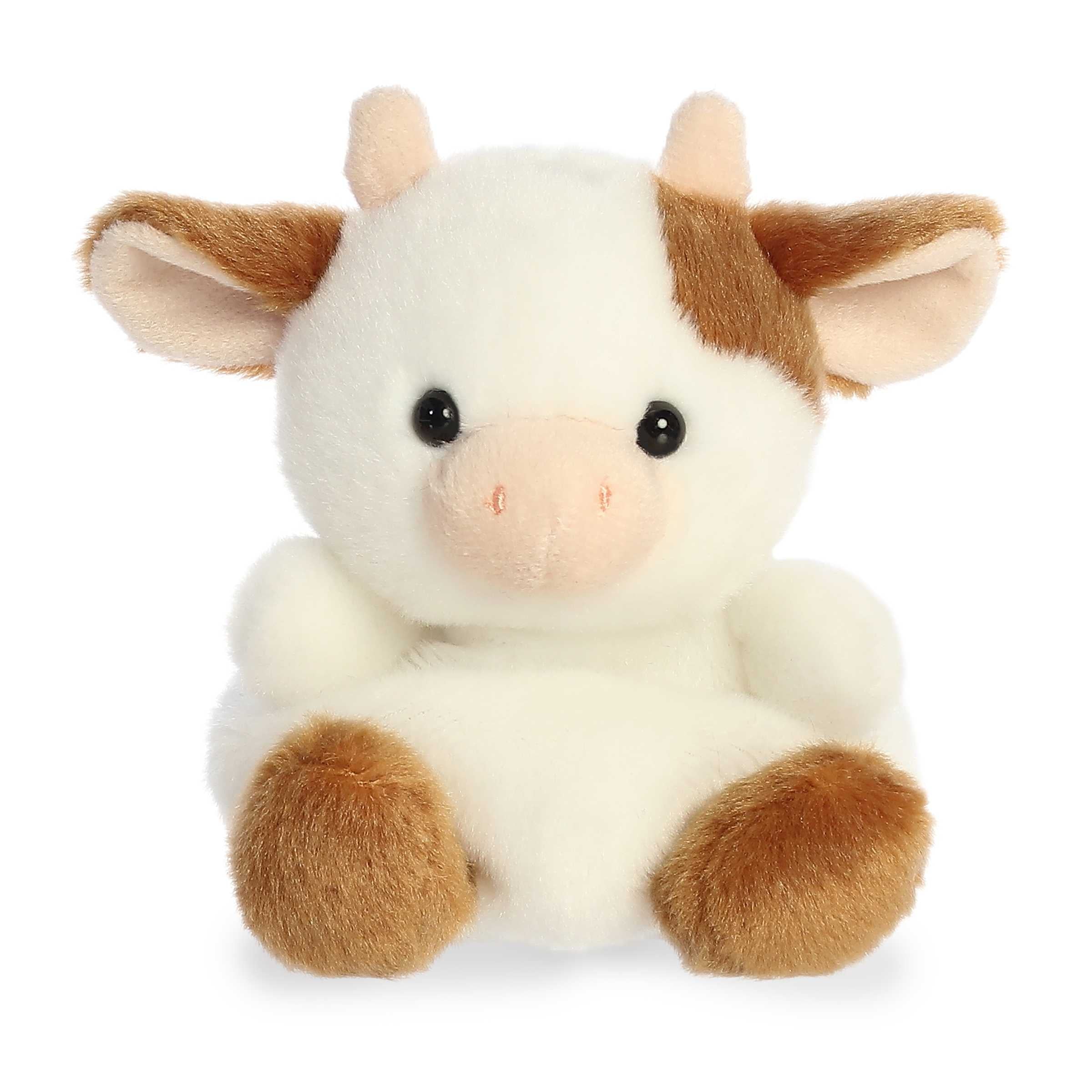 Plush toy of a white and brown cow with a gentle expression and soft ears, fits in the palm of your hand