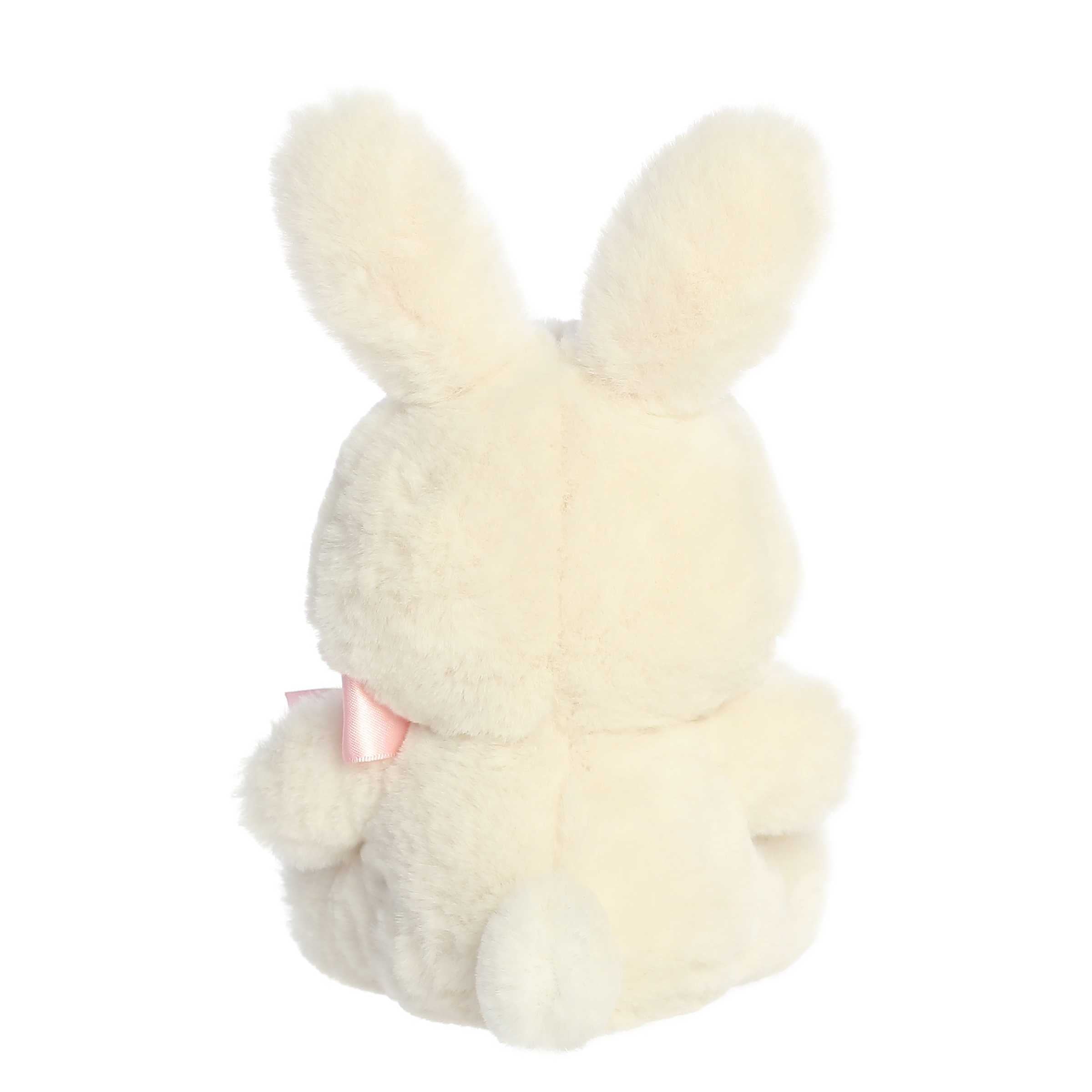 A plush bunny in a fluffy taupe colored fur coat and an adorable purple bow around its neck